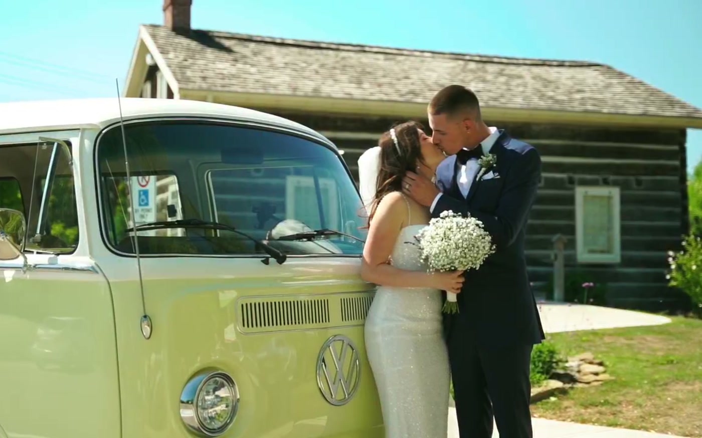 Couple with their vintage van on the wedding day